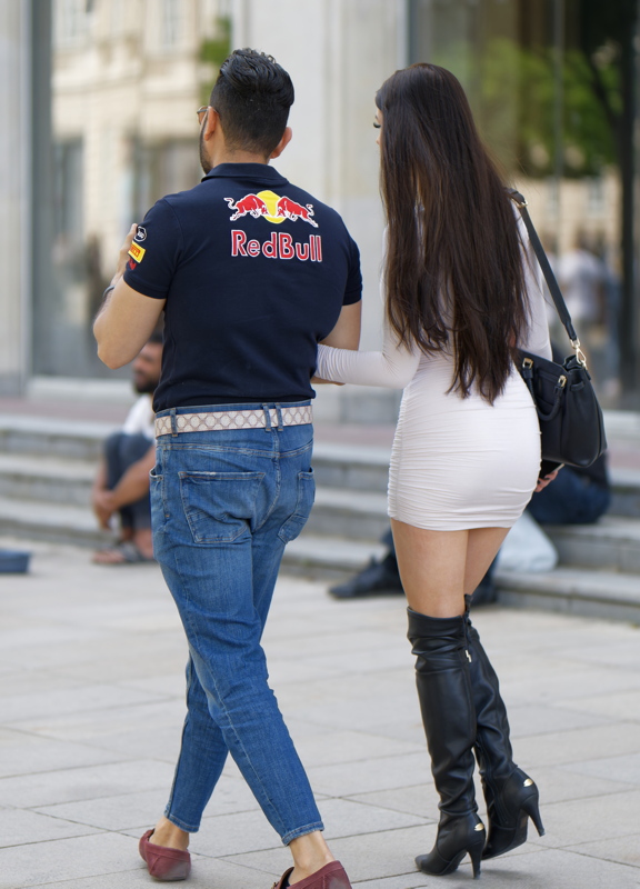 Sexy young woman walking with a friend